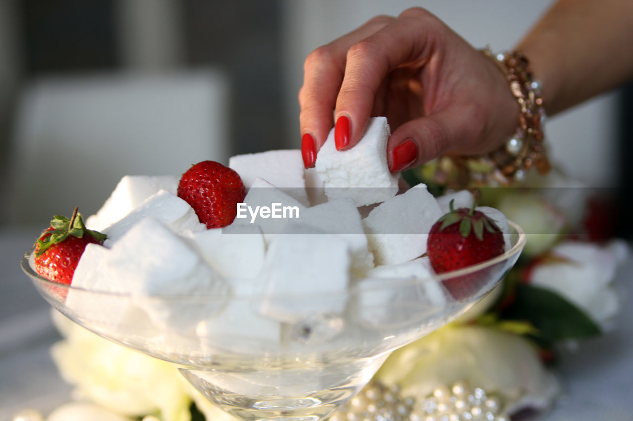 Close-up of hand holding sugar cube 