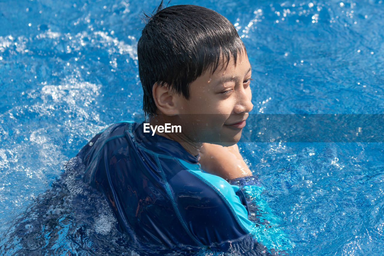 GIRL LOOKING AT SWIMMING POOL