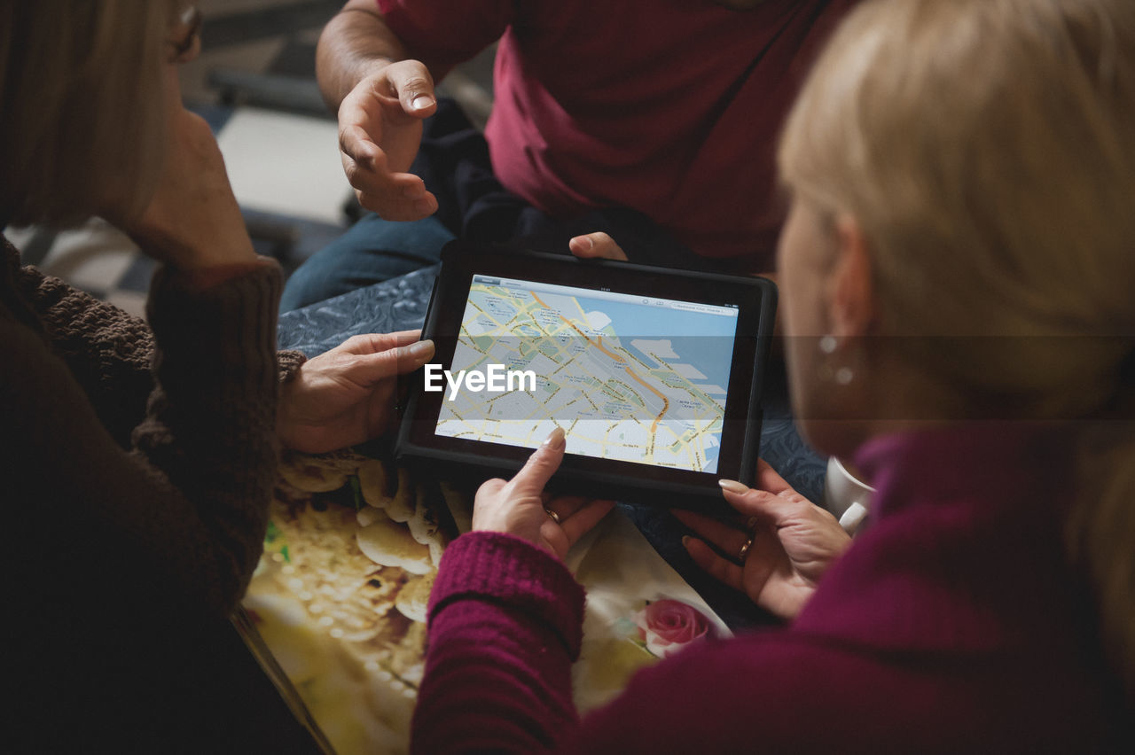 People looking at map on digital tablet