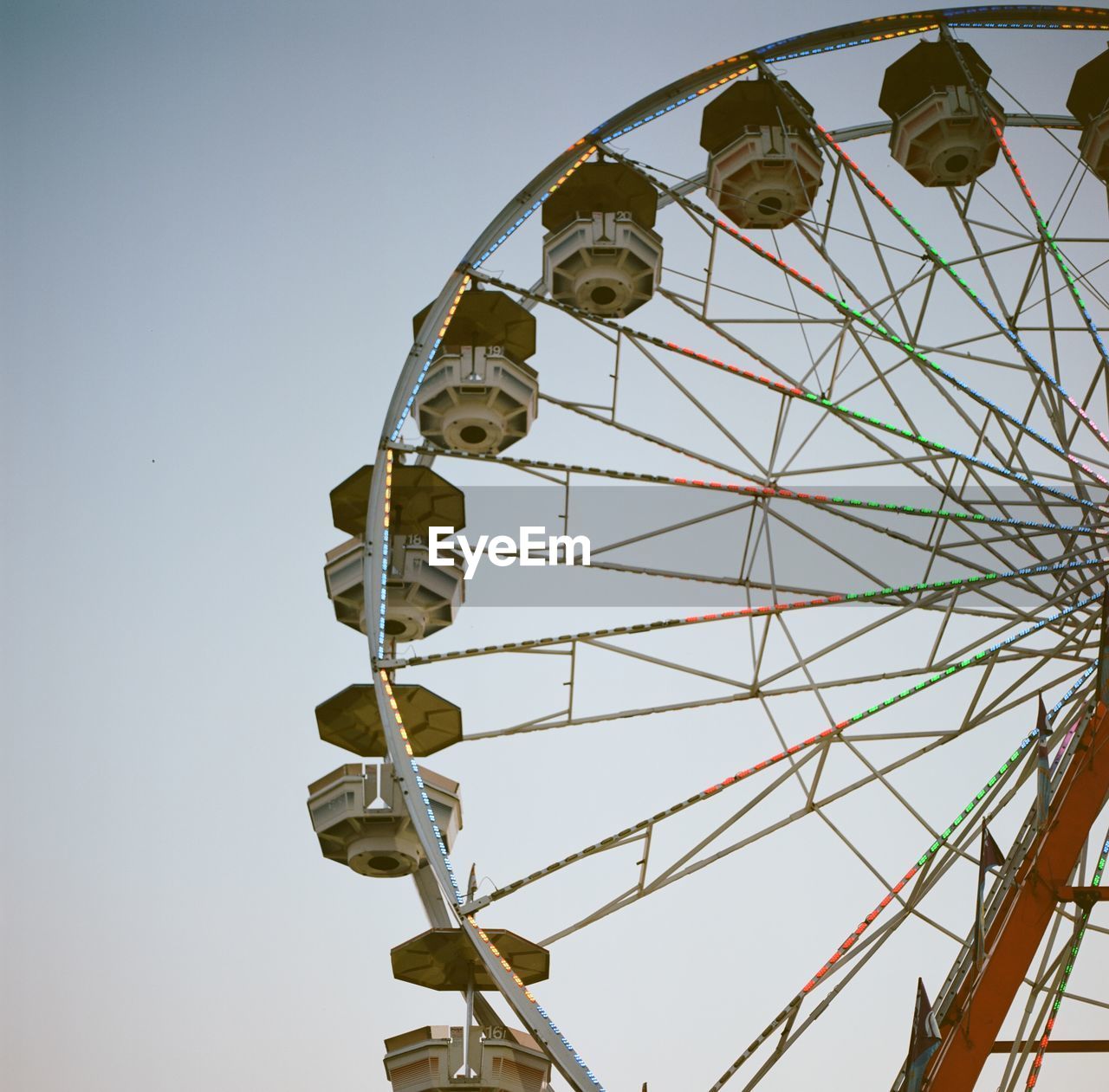 Low angle view of ferris wheel against clear sky