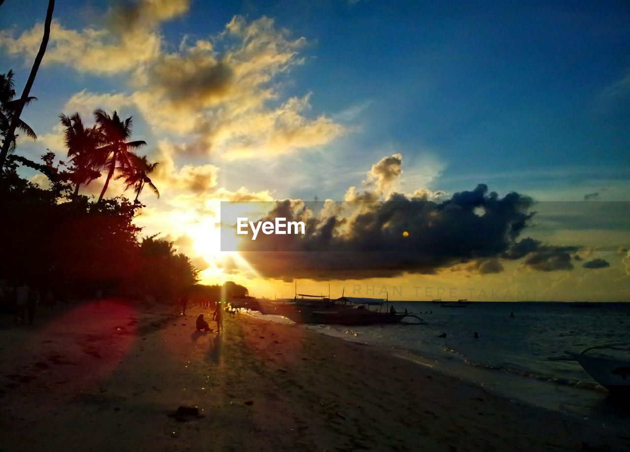 VIEW OF BEACH AGAINST SKY DURING SUNSET