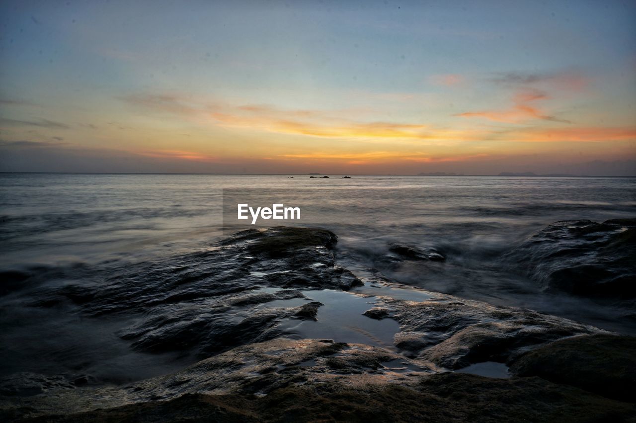 Scenic view of sea against cloudy sky