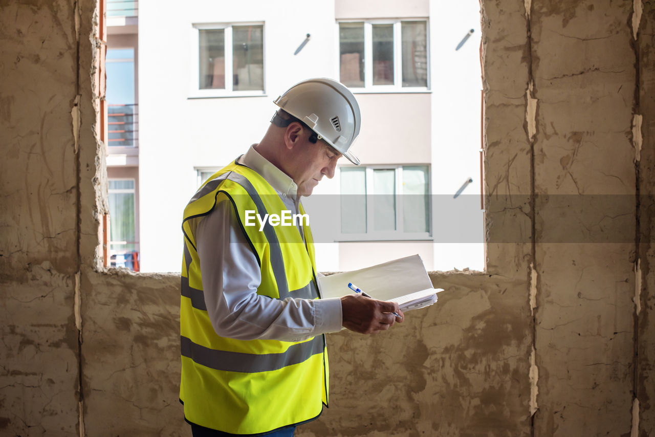 Side view of engineer working at construction site