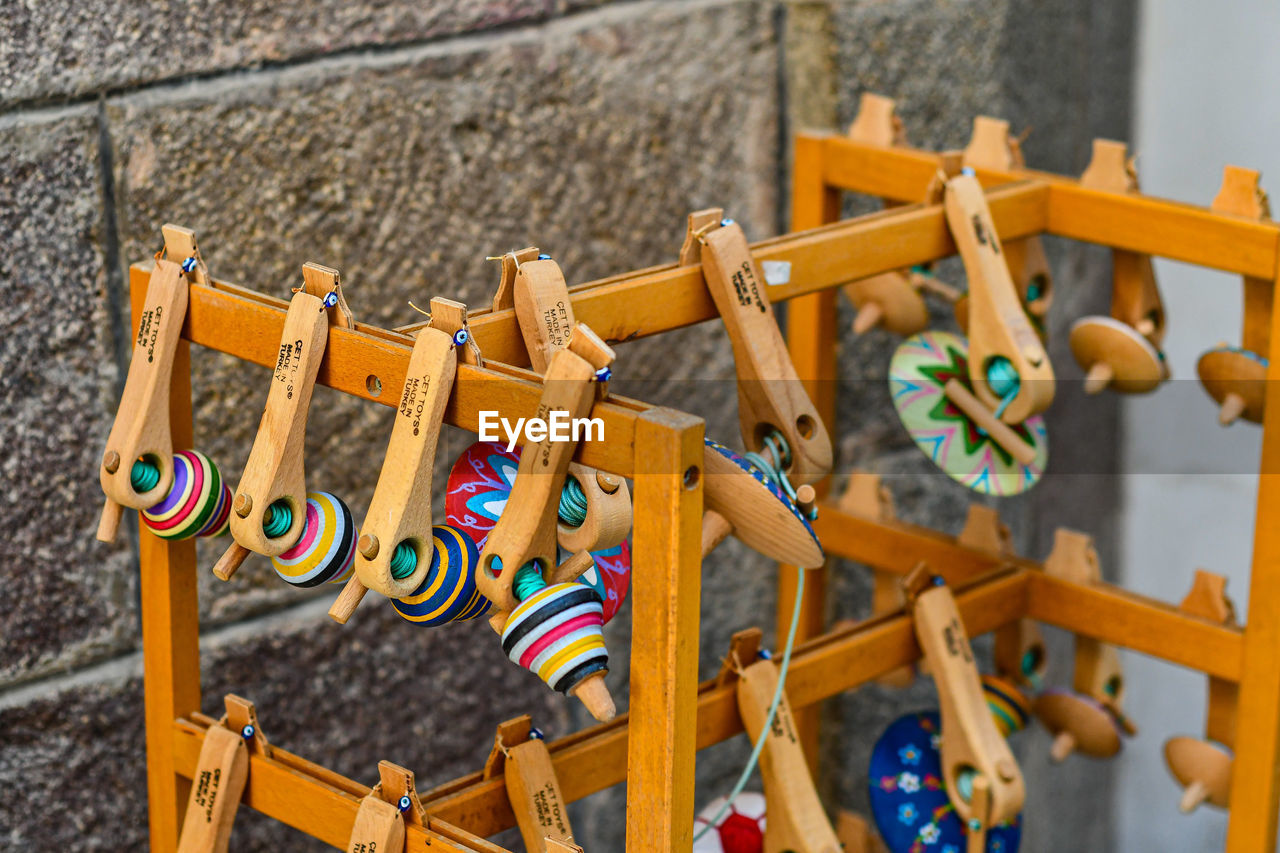 HIGH ANGLE VIEW OF MULTI COLORED TOYS ON WOODEN FLOOR