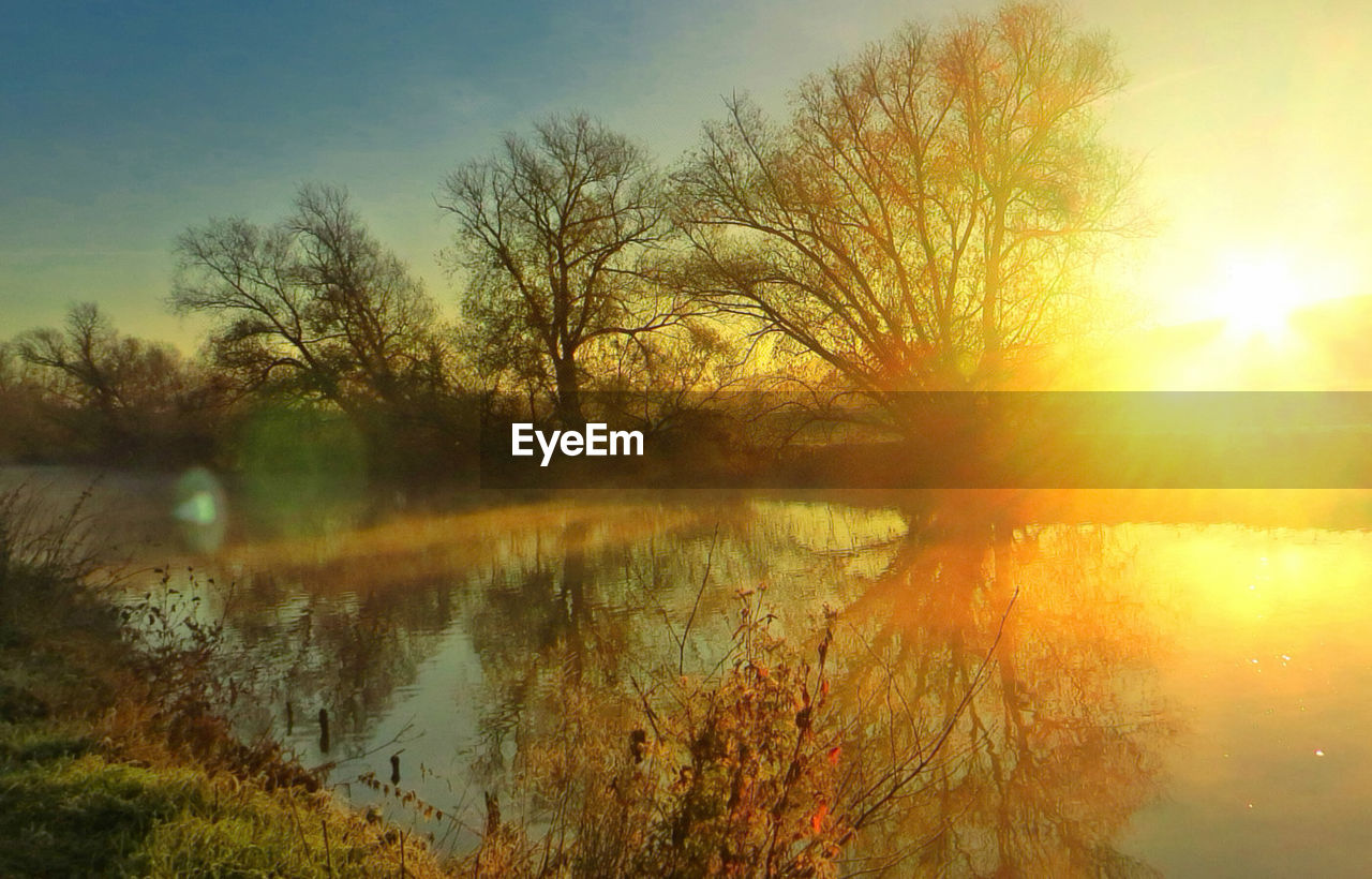 SCENIC VIEW OF LAKE AT SUNSET