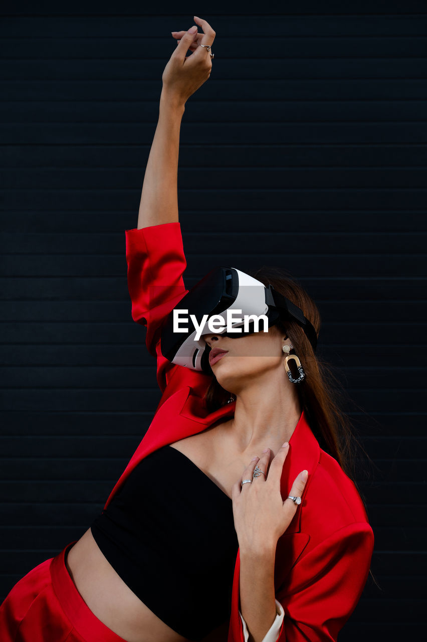 one person, adult, red, clothing, young adult, women, sports, arm, arms raised, human limb, portrait, limb, indoors, studio shot, athlete, lifestyles, sports clothing, fashion, waist up, arts culture and entertainment, vitality, hand, female, dancing
