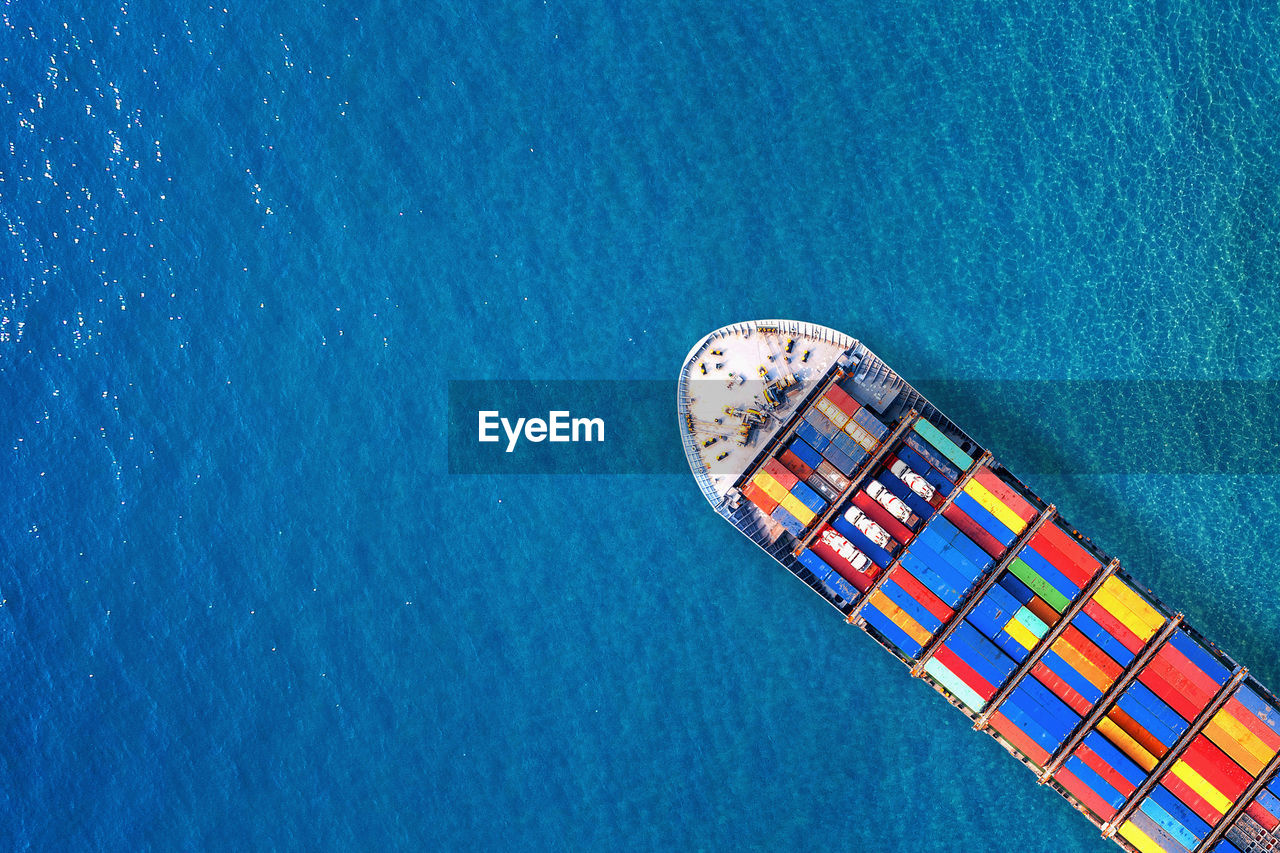 Aerial view of cargo containers in ship on sea