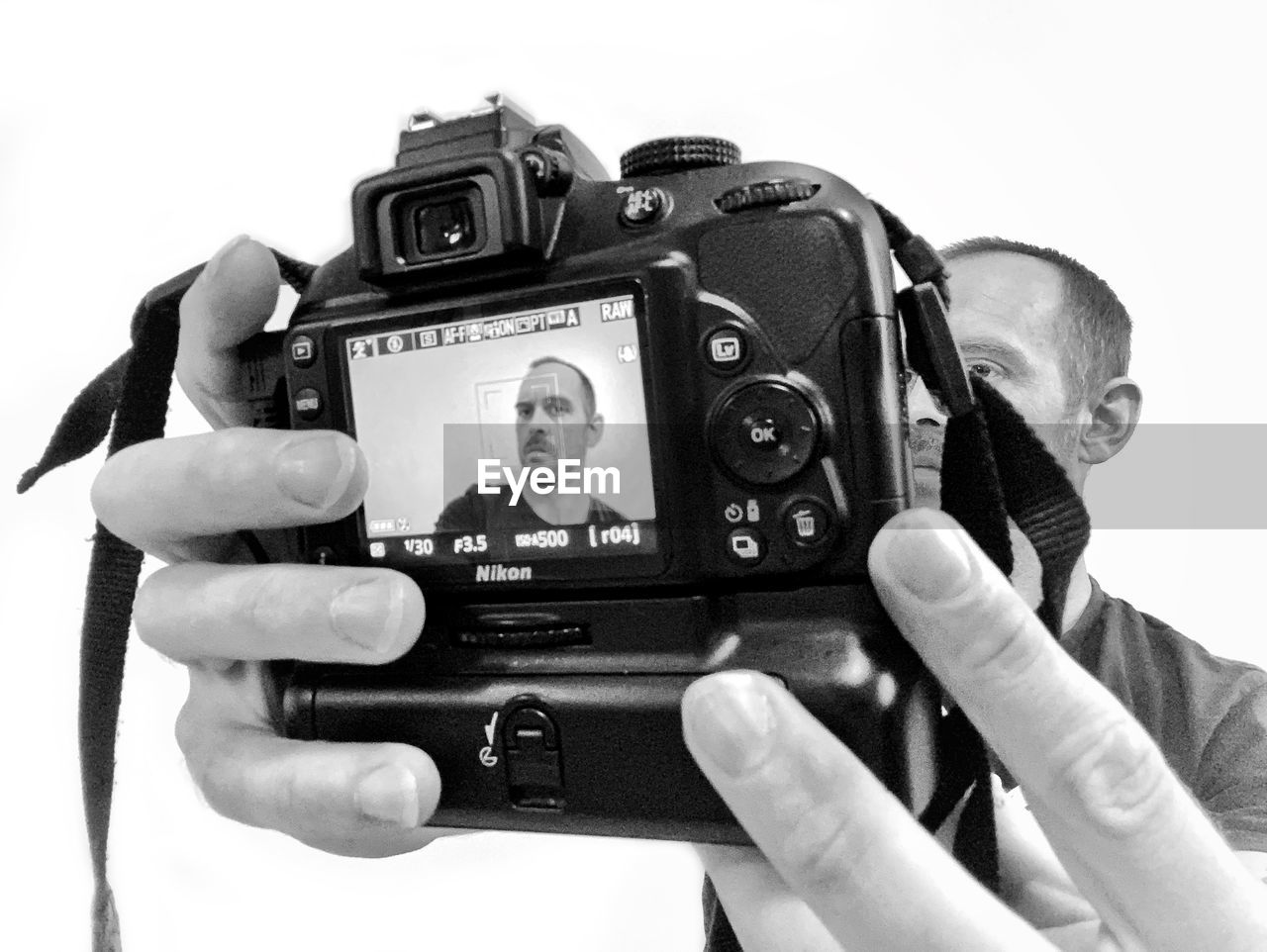 CLOSE-UP OF MAN PHOTOGRAPHING CAMERA