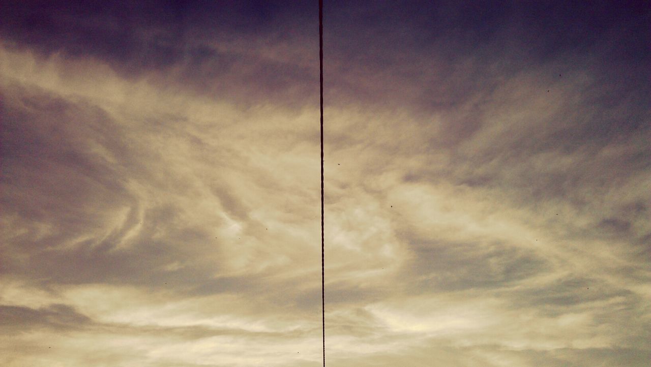 LOW ANGLE VIEW OF POWER LINES AGAINST CLOUDY SKY