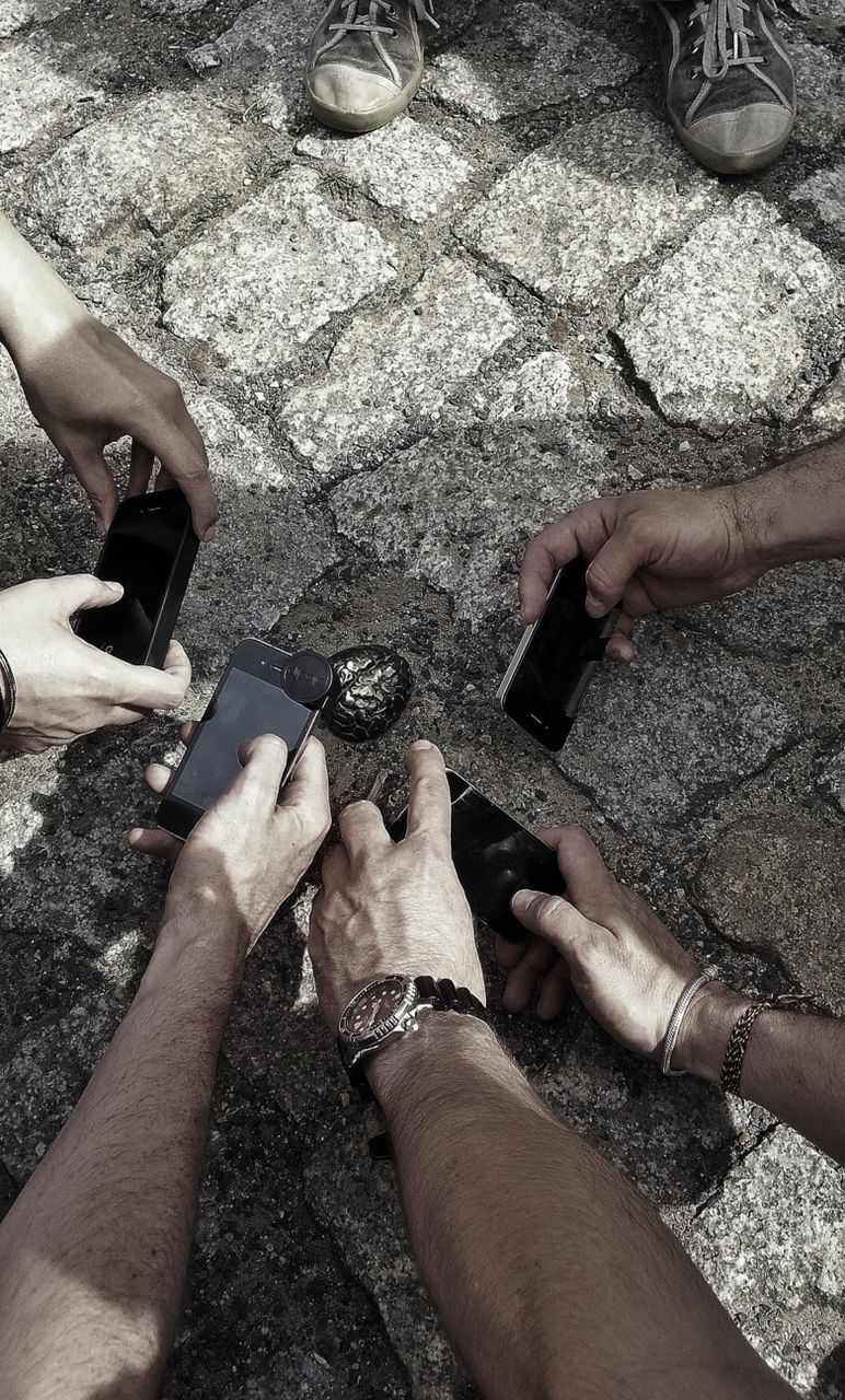 Close-up of hands photographing with mobile phones