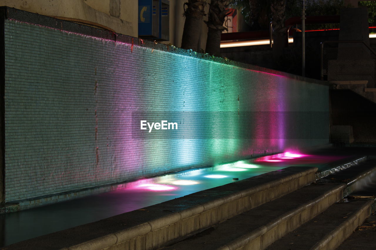 Illuminated water fountain at night