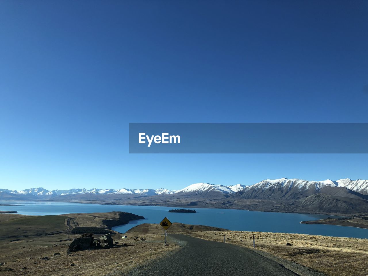 Scenic view of snowcapped mountains against clear blue sky