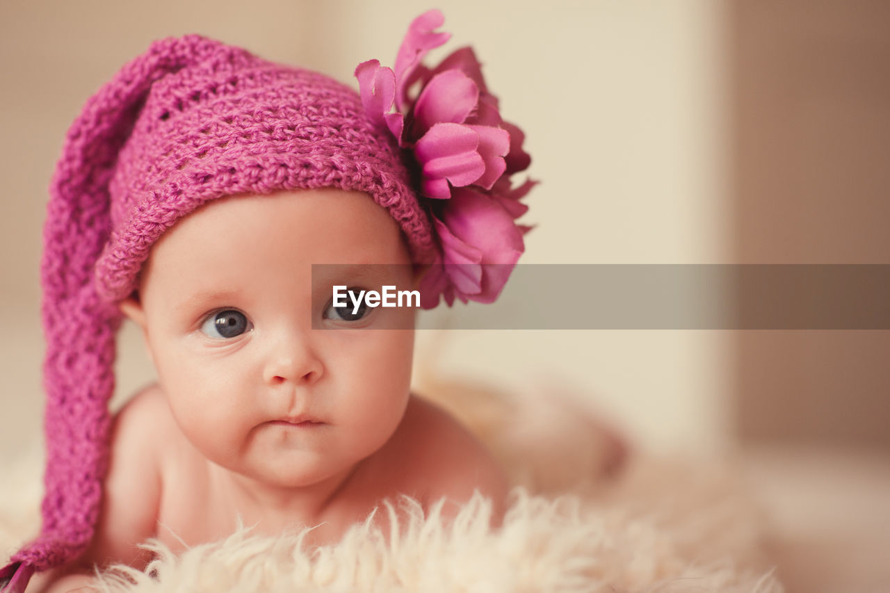 pink, child, childhood, portrait, baby, cute, one person, innocence, clothing, toddler, indoors, skin, headshot, looking at camera, baby clothing, hat, babyhood, emotion, close-up, women, fashion accessory, front view, flower, female, eye, person, looking, softness, fashion, portrait photography, nature, blue eyes, crochet