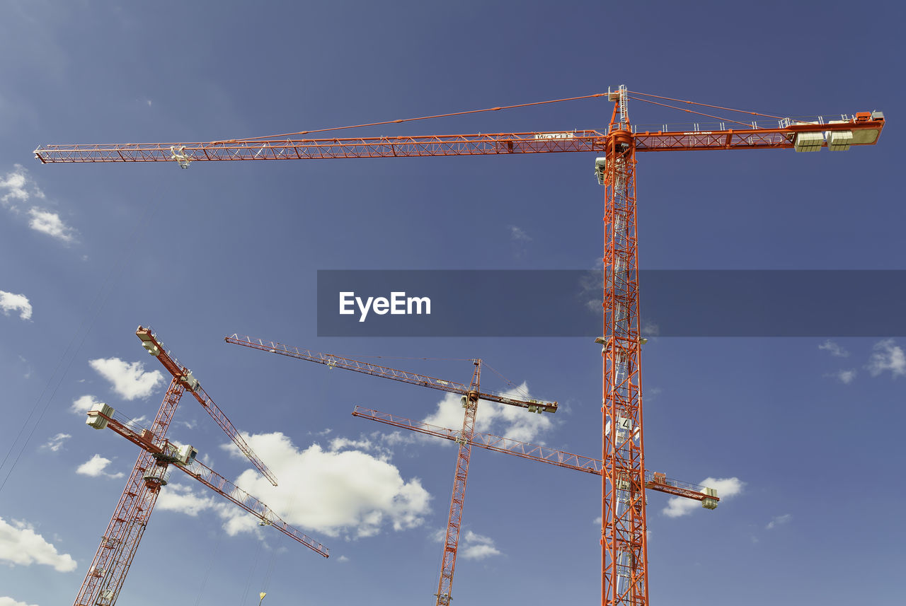 Low angle view of crane against sky