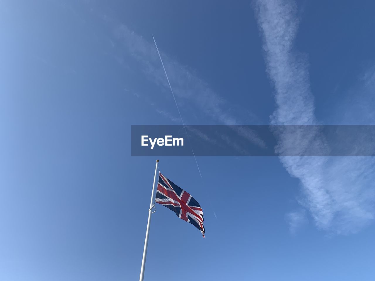 Low angle view of flag against blue sky