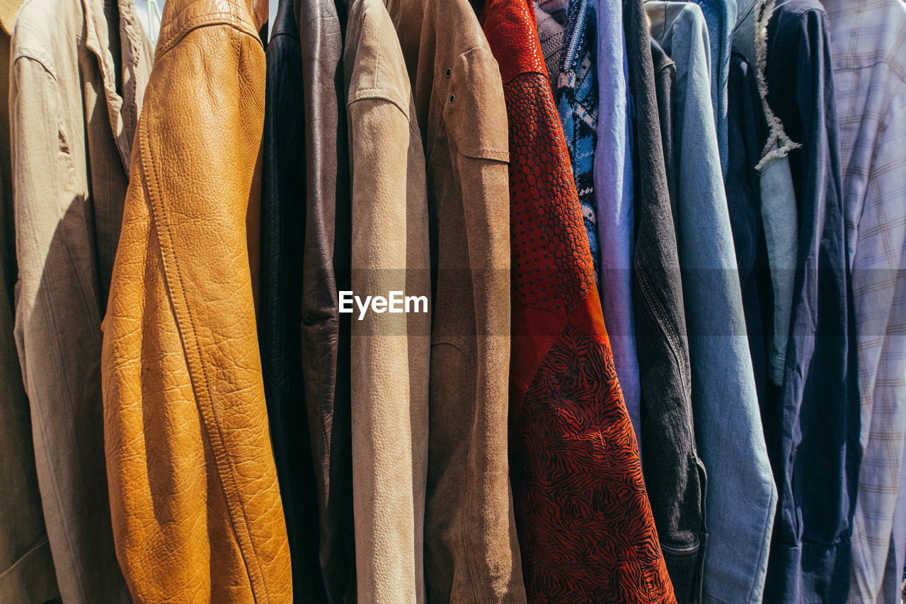 Close-up of shirts hanging in market stall for sale