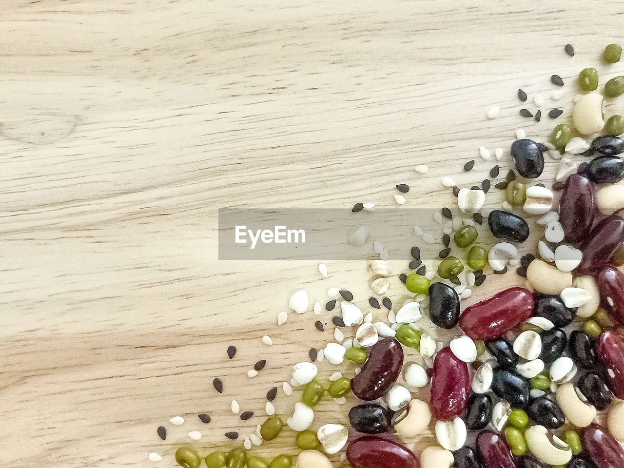 Mix beans on wooden background.