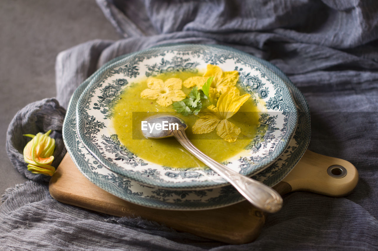 Pumpkin soup in a plate with a blue ornament autumn menu, vegetarian food