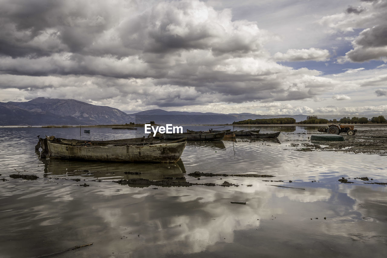 VIEW OF HARBOR AGAINST CLOUDY SKY