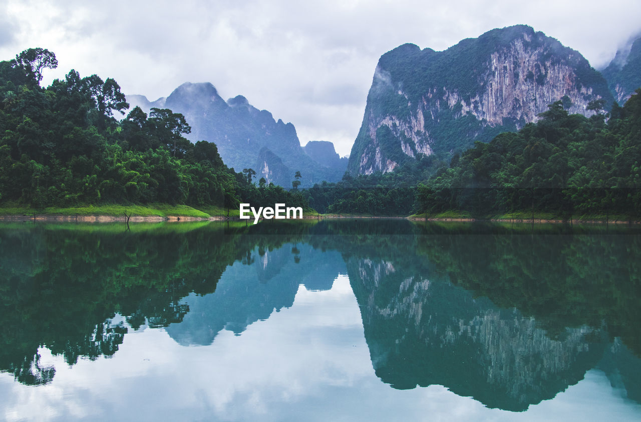 Scenic view of lake and mountains against sky