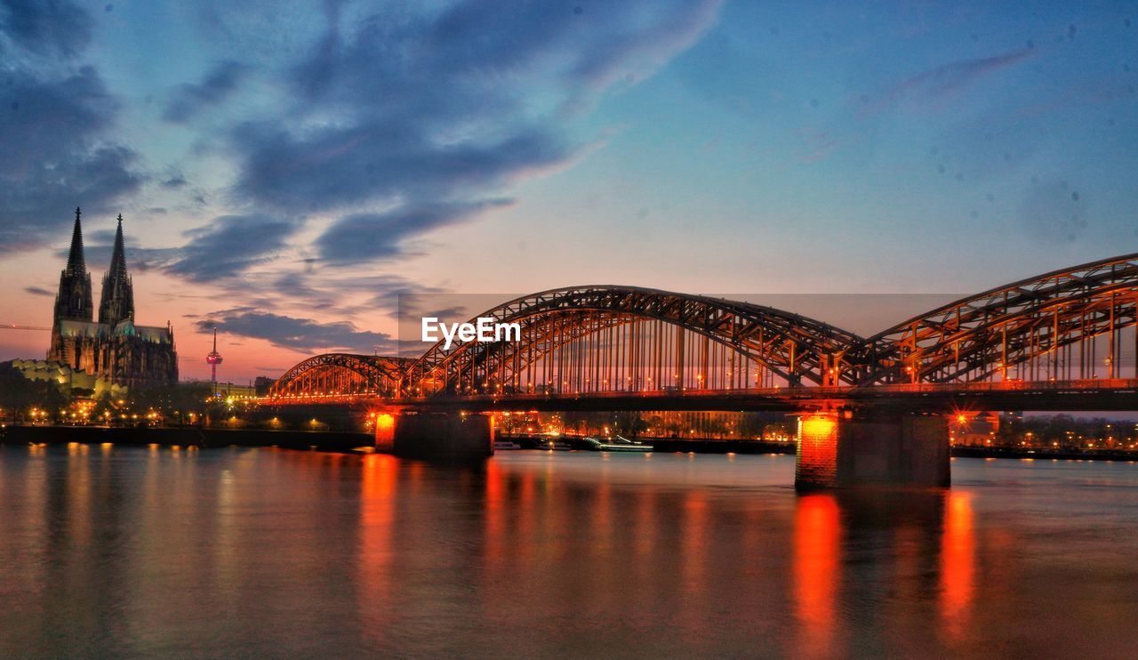architecture, built structure, travel destinations, dusk, bridge, water, city, evening, cityscape, night, reflection, sky, landmark, transportation, illuminated, sunset, building exterior, nature, twilight, landscape, travel, arts culture and entertainment, skyline, urban skyline, building, cloud, tourism, cantilever bridge, river, no people, outdoors, harbor, business finance and industry, scenics - nature