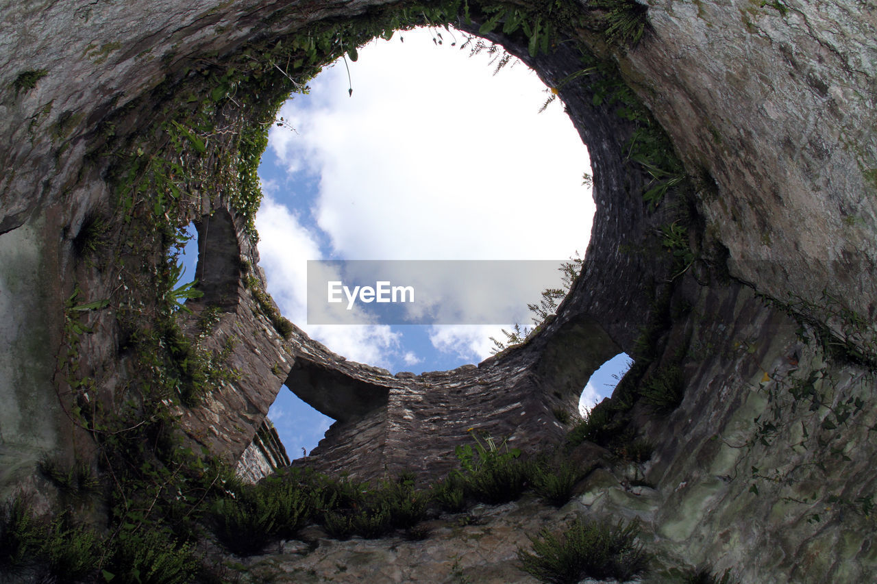 Low angle view of ruined building against sky