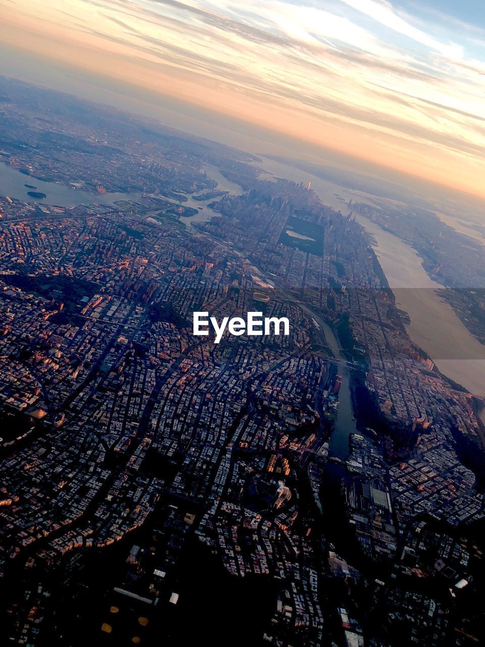 Aerial view of city against sky during sunset