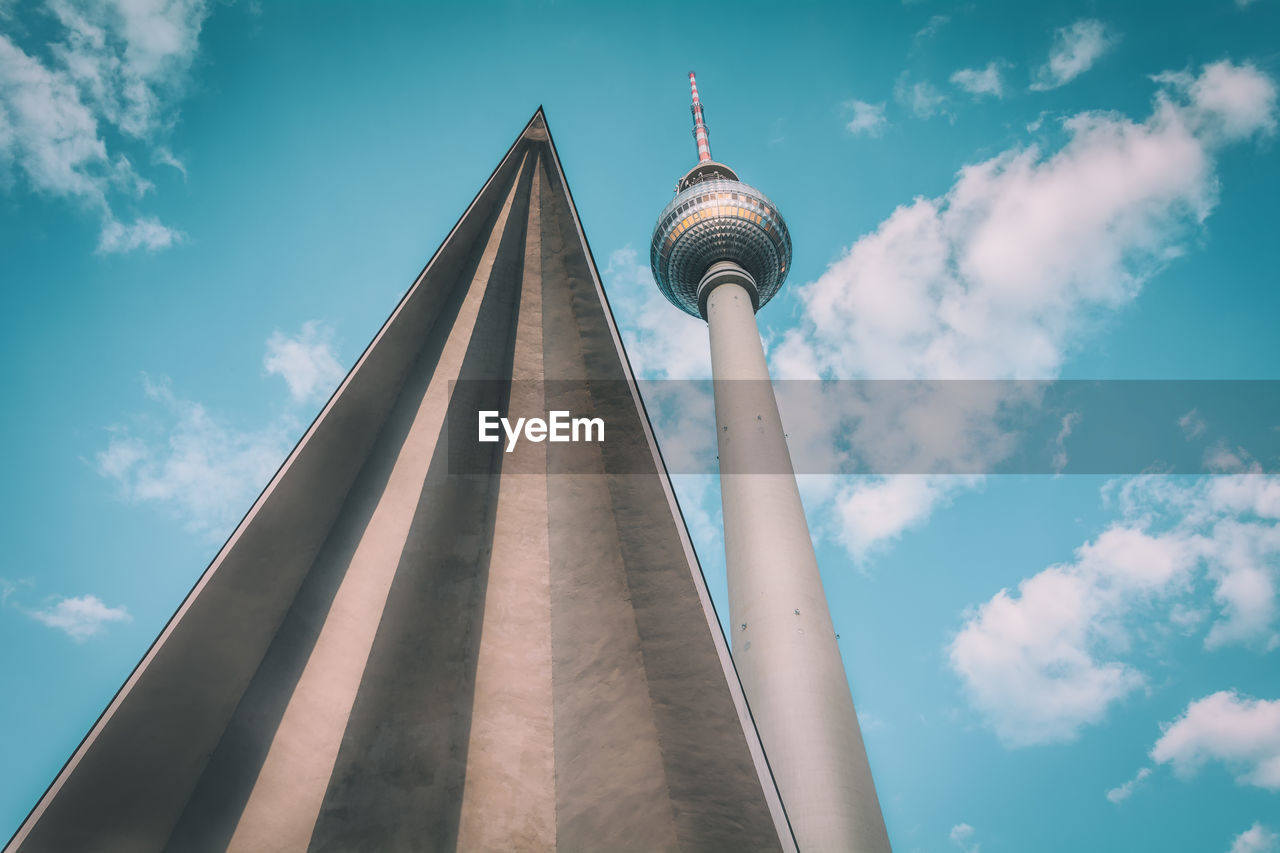 Low angle view of fernsehturm by triangle shape against sky