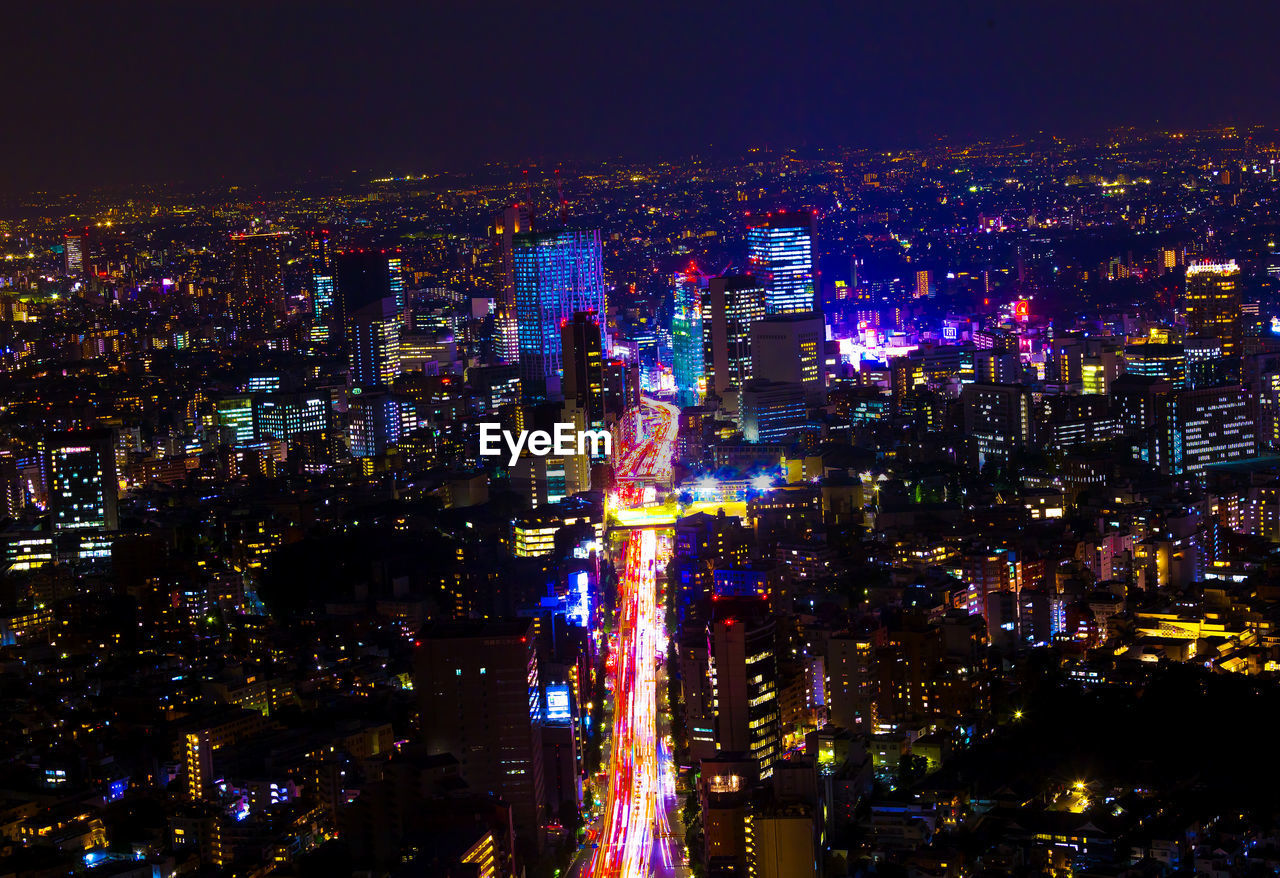 High angle view of illuminated city buildings at night