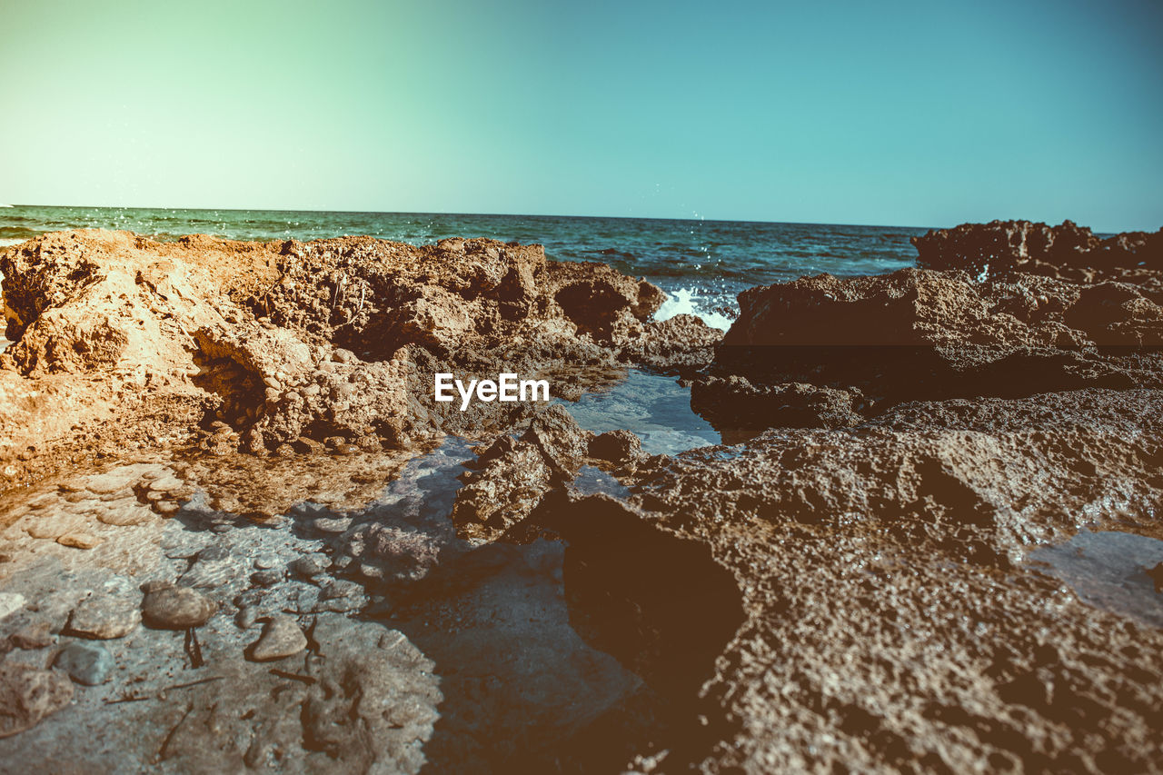 Scenic view of sea against clear blue sky