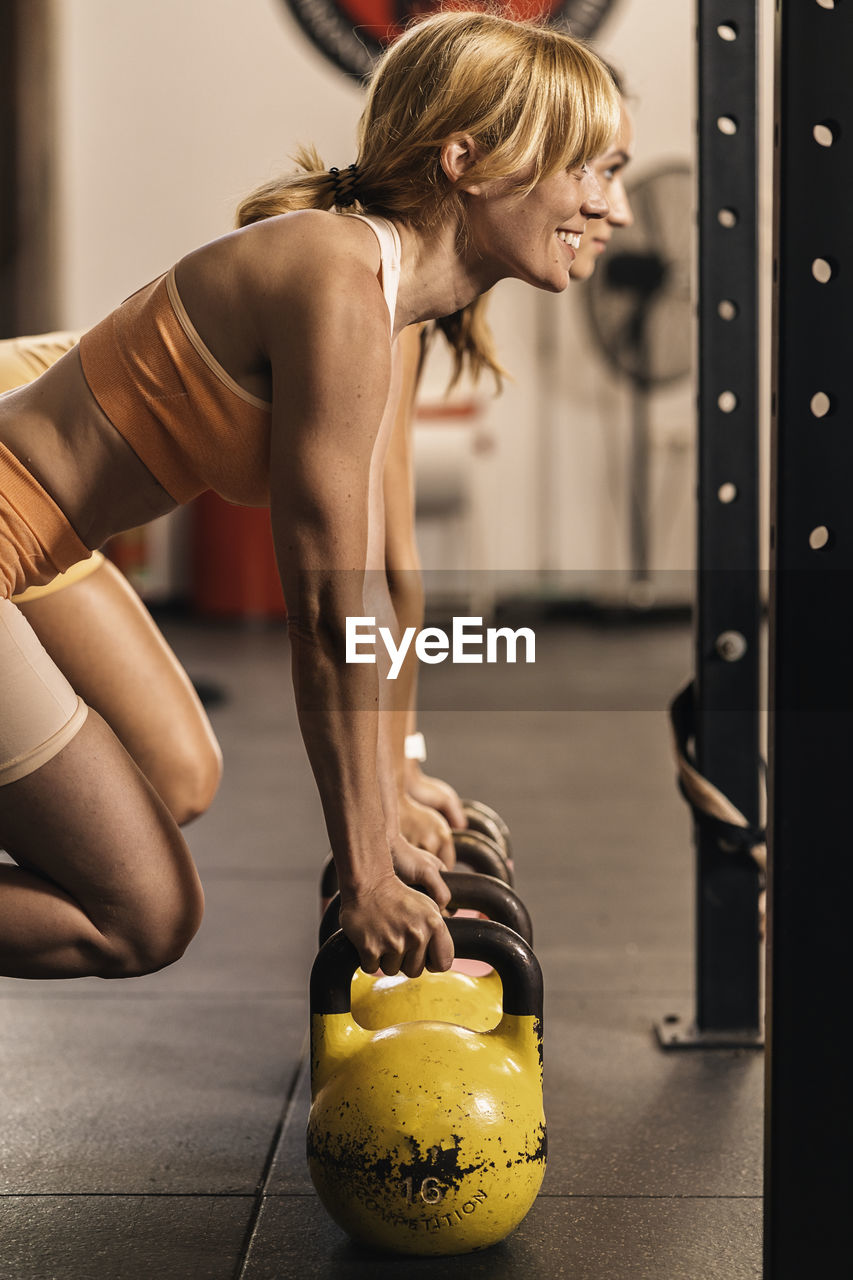 Couple of female athletes concentrated a training session in a gym  hall effort and improvement