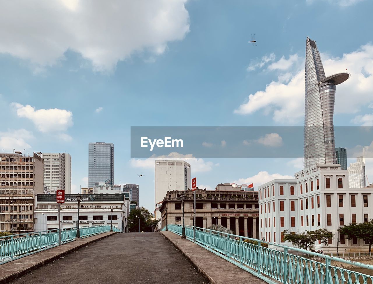 Modern buildings in city against cloudy sky