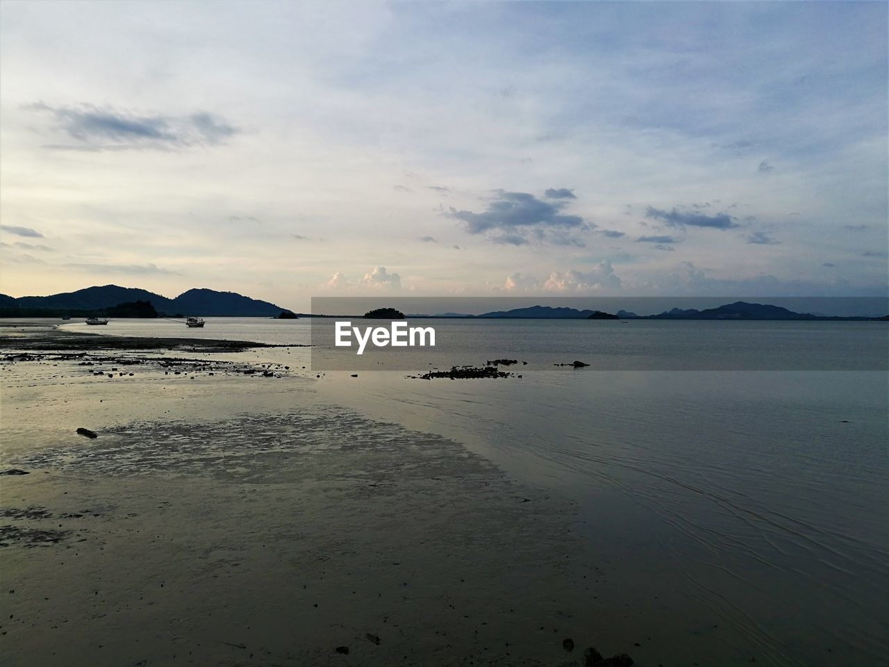 SCENIC VIEW OF BEACH AGAINST SKY DURING SUNSET