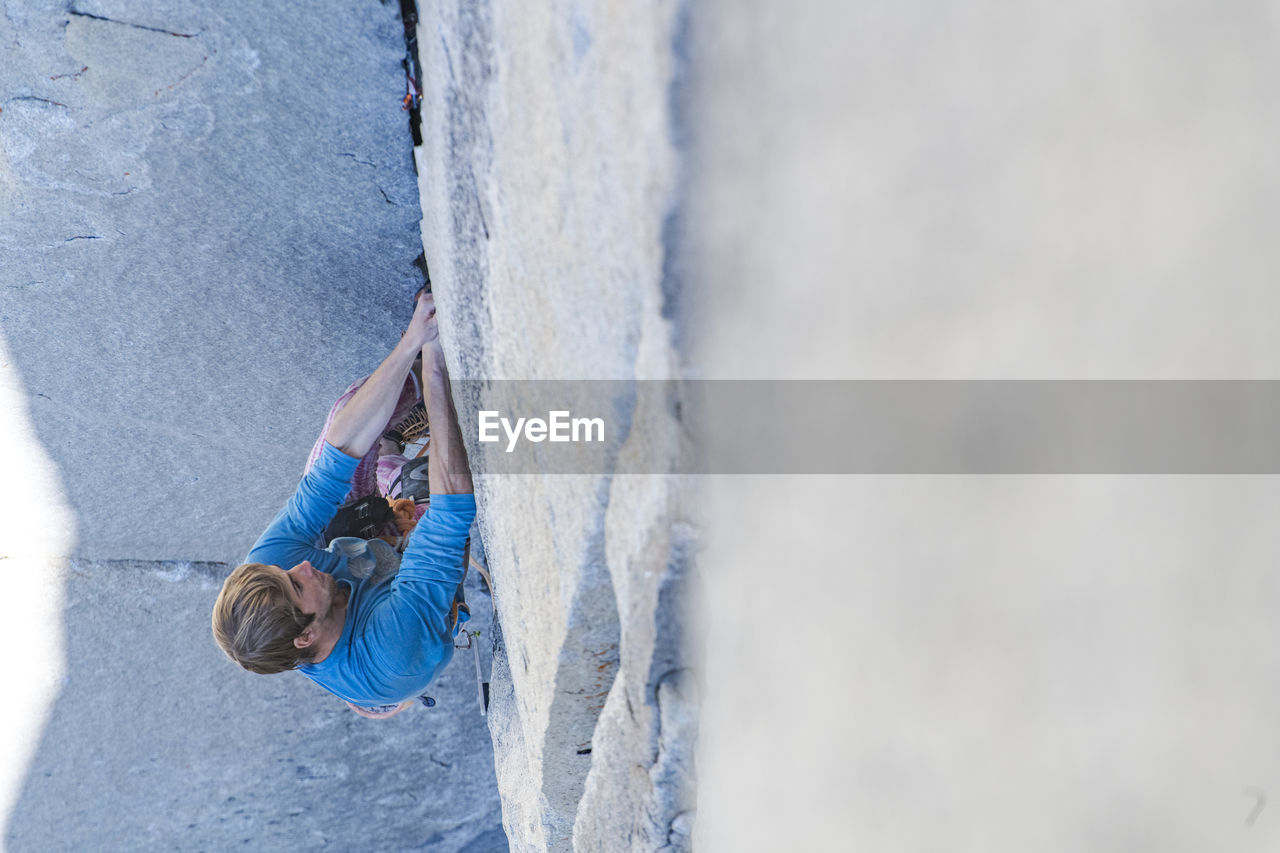 Climber lead climbing changing corners on the nose, yosemite, capitan