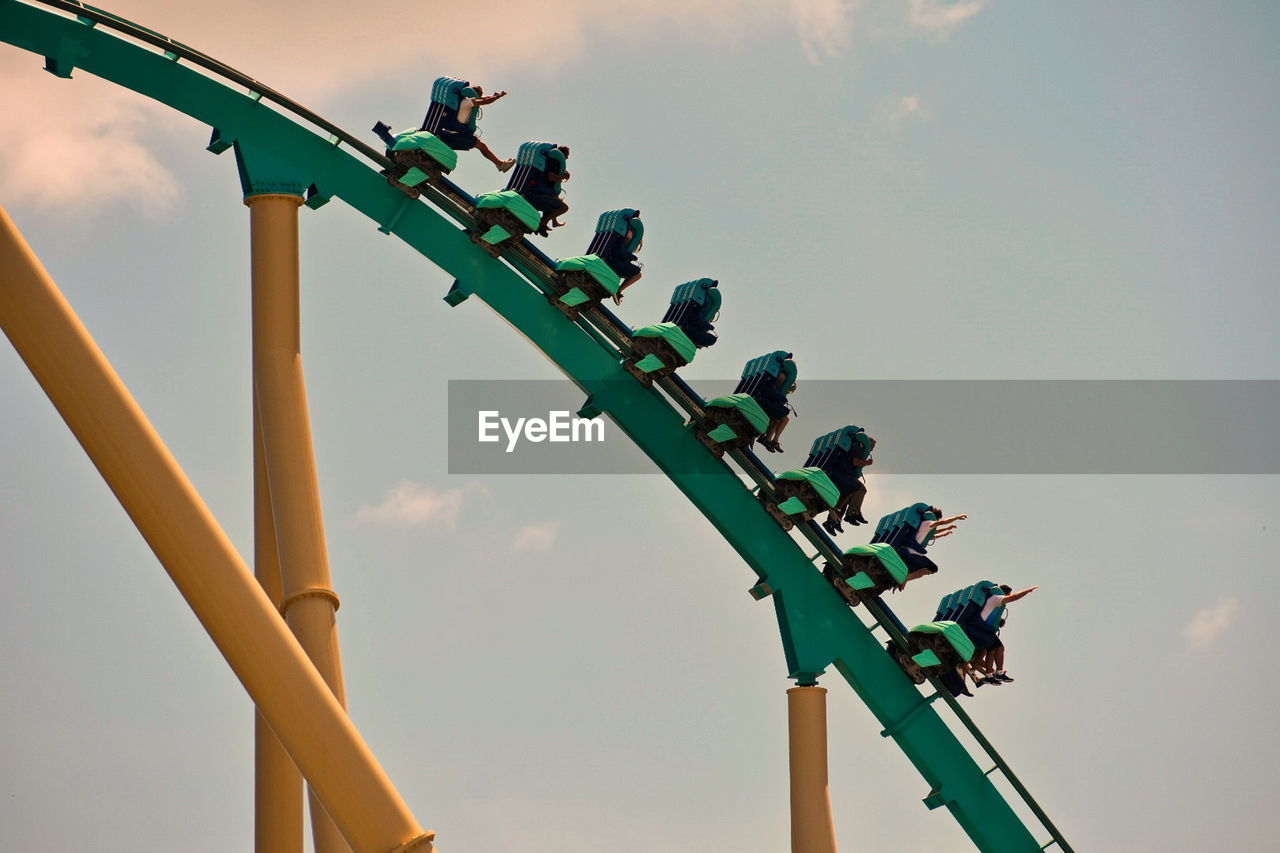 A group of people enjoys a kraken roller coaster ride at seaworld ocean marine theme park