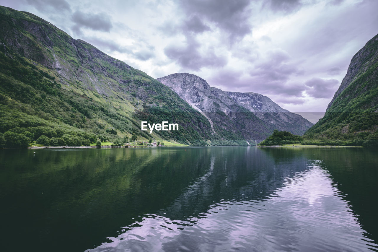 Scenic view of lake and mountains against sky