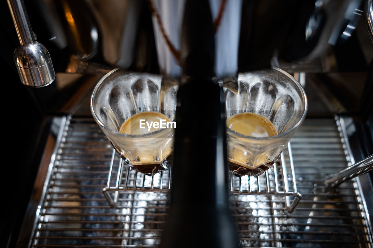 Fresh espresso shot pouring out of machine.