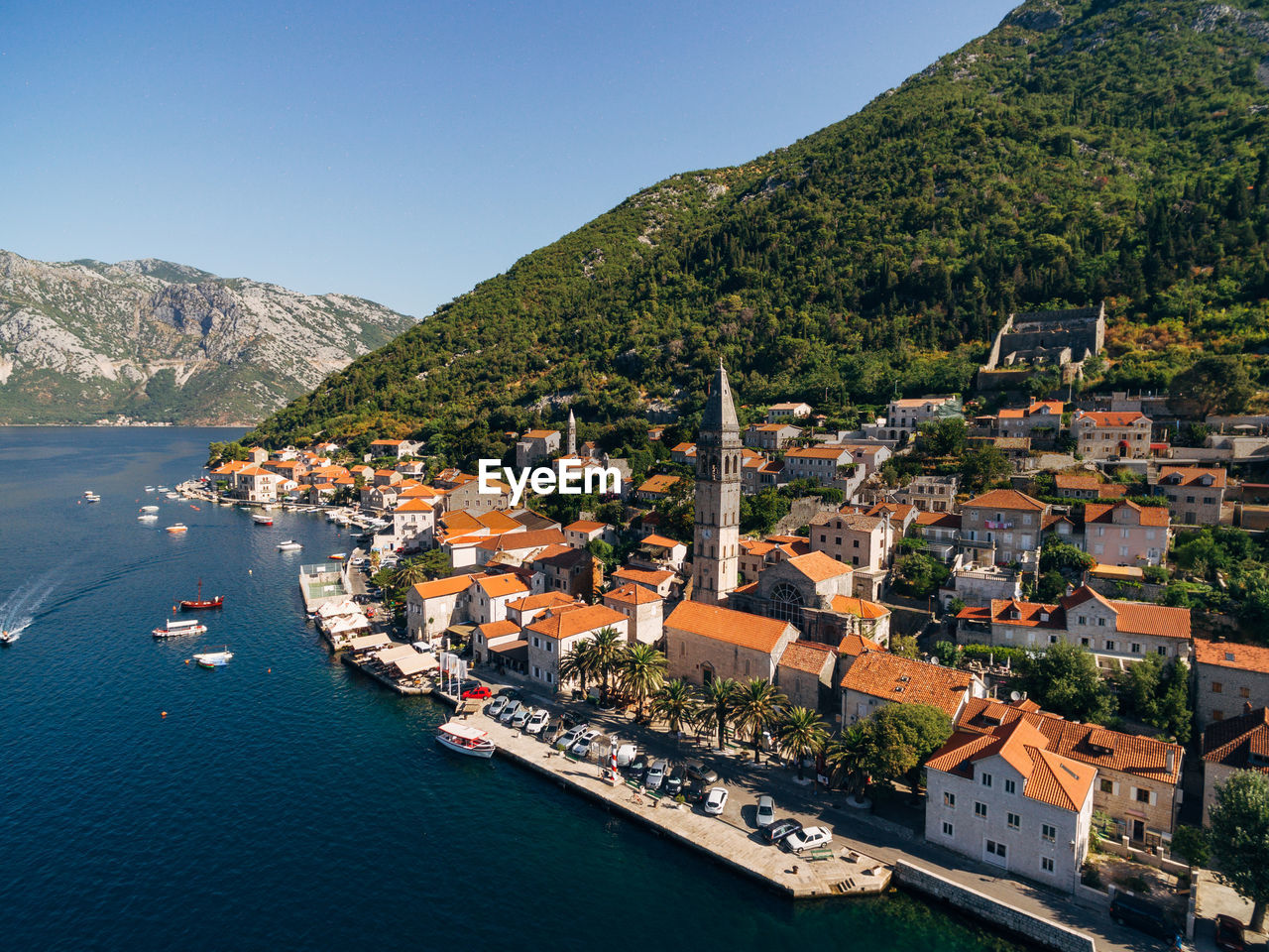 HIGH ANGLE VIEW OF TOWNSCAPE AND SEA AGAINST SKY