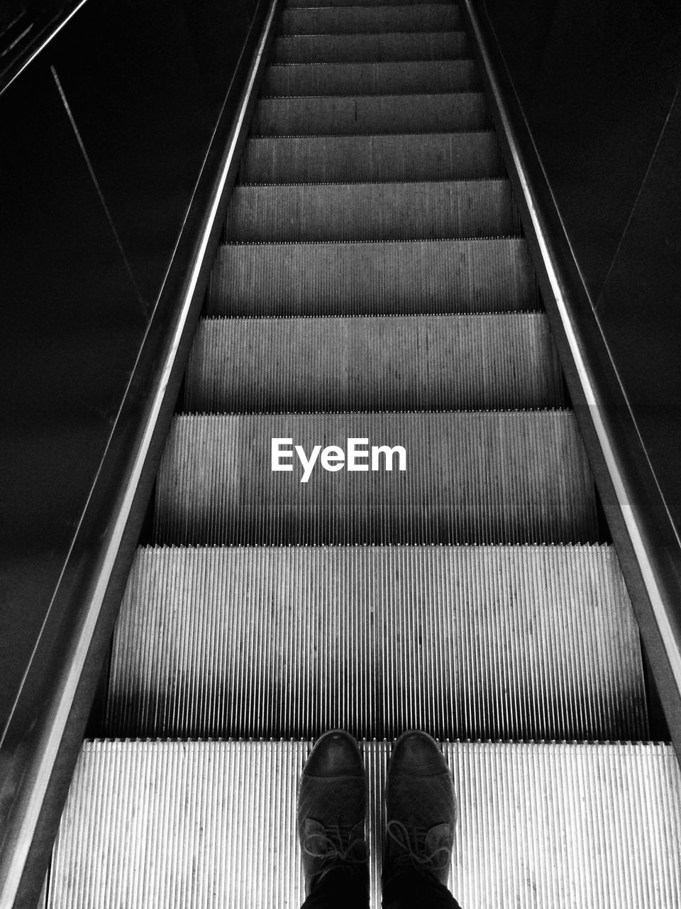 Close-up of man on escalator