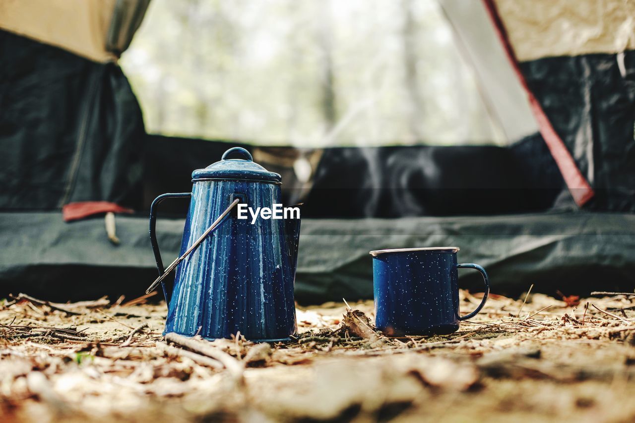 Kettle and cup in front of tent photo