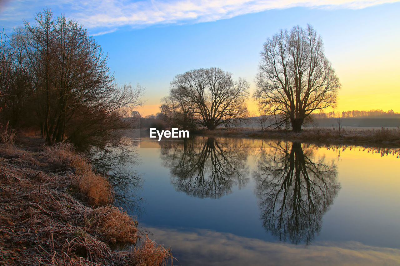 Scenic view of lake against sky during sunset