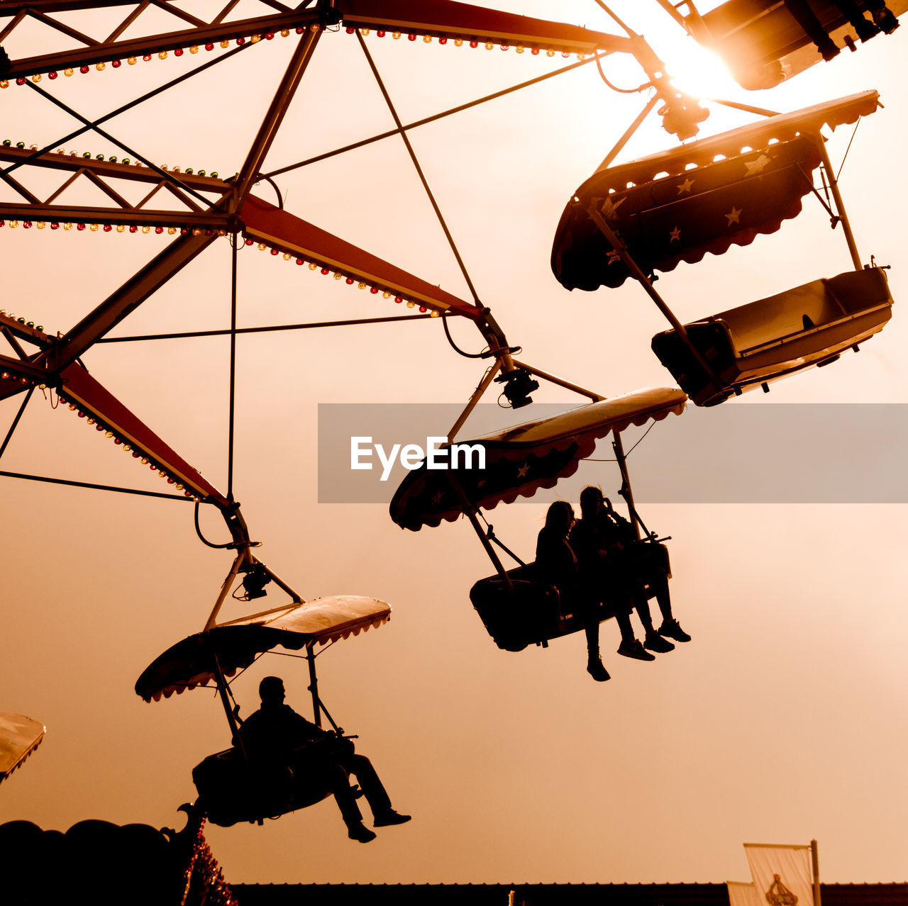 LOW ANGLE VIEW OF SILHOUETTE SWING RIDE