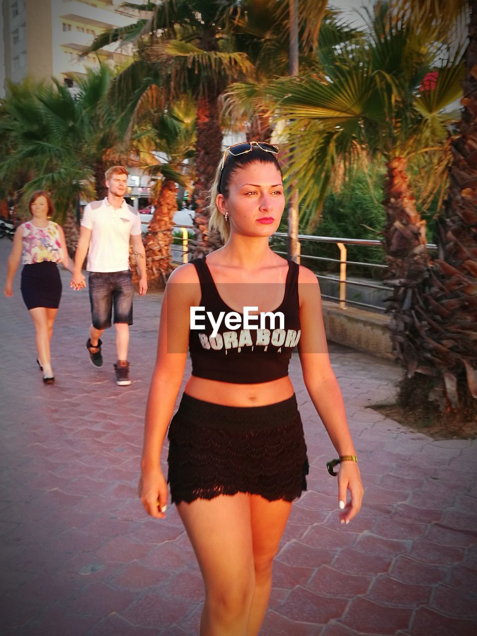 Young woman walking at pathway during sunset