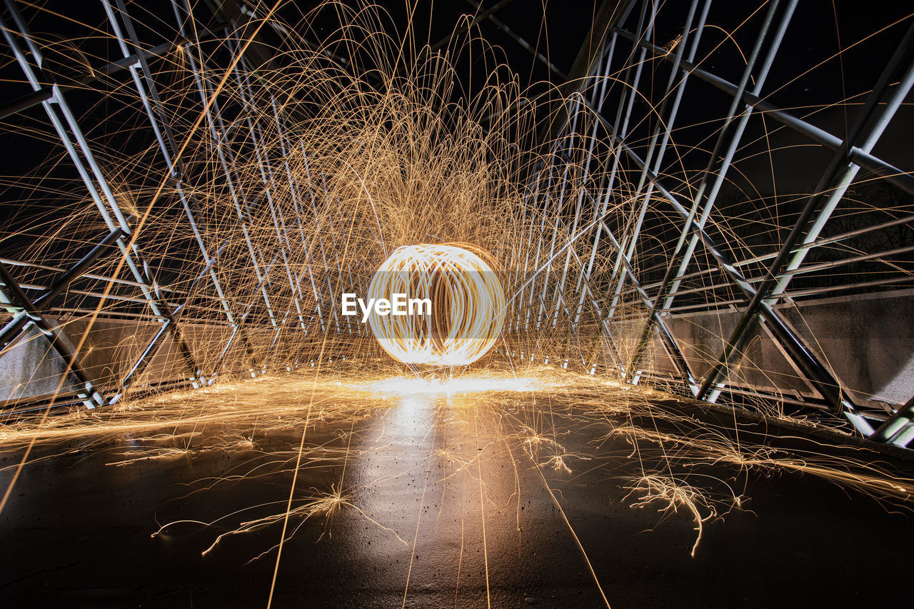 Wire wool spinning on road at night