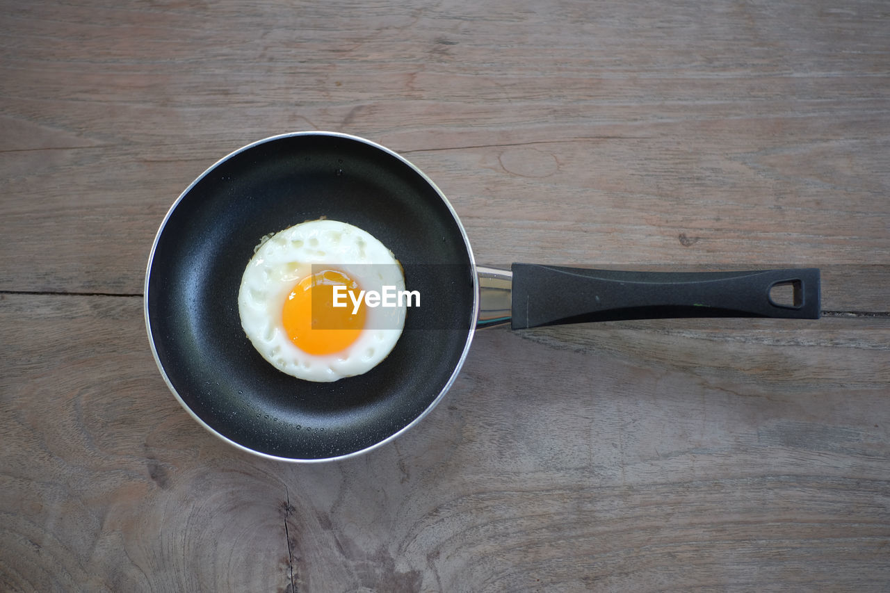 Directly above shot of fried egg in pan on table