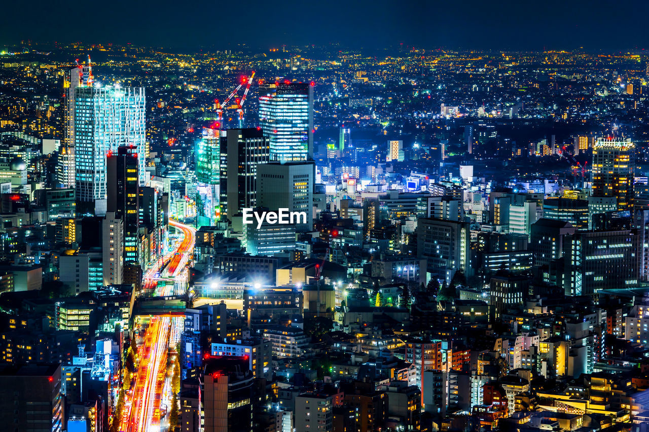 High angle view of illuminated city buildings at night