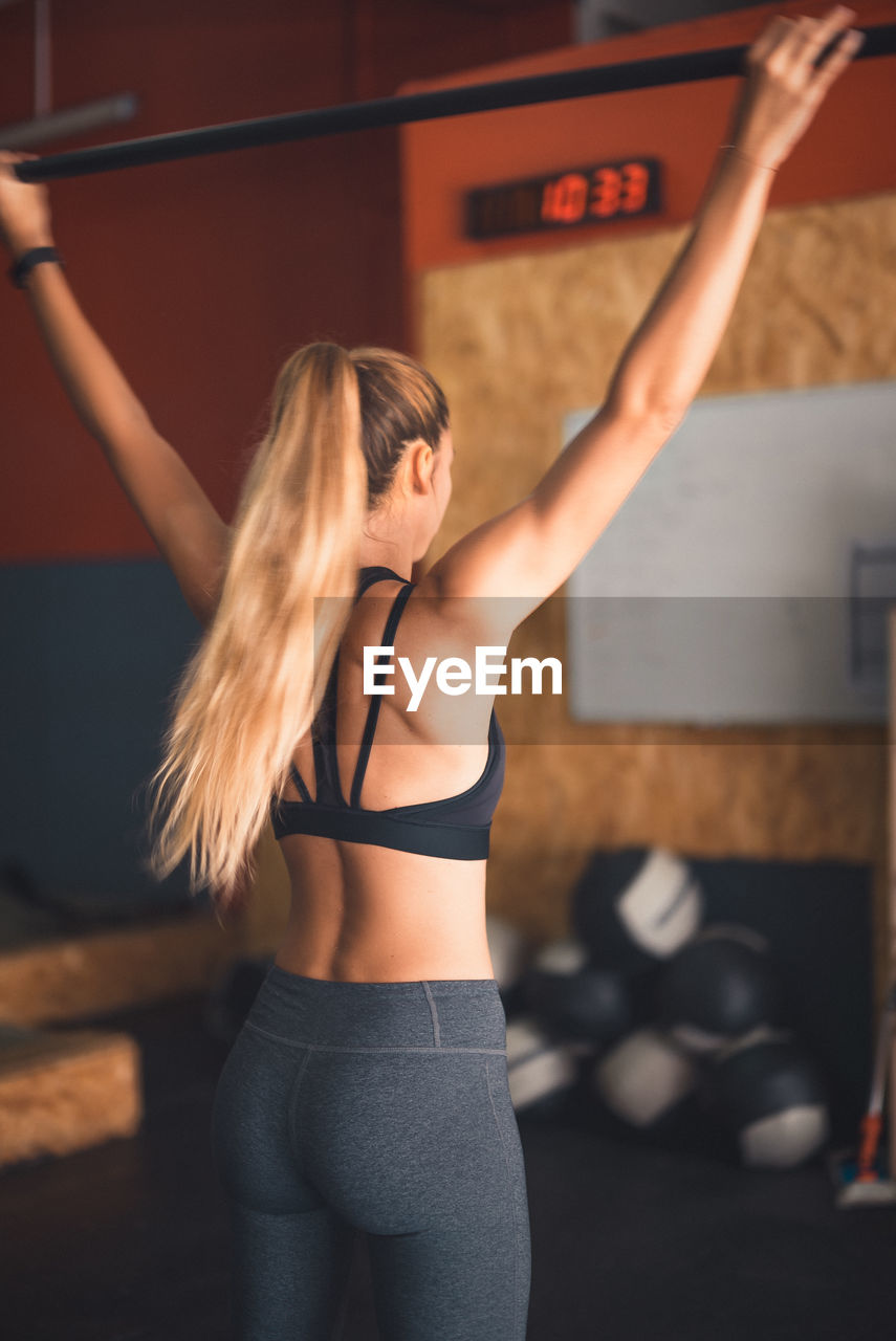 Young woman exercising in gym