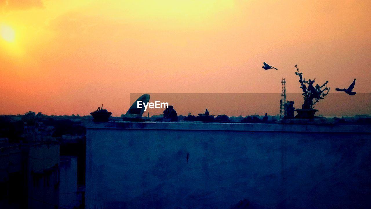 CRANES IN CITY AGAINST SKY