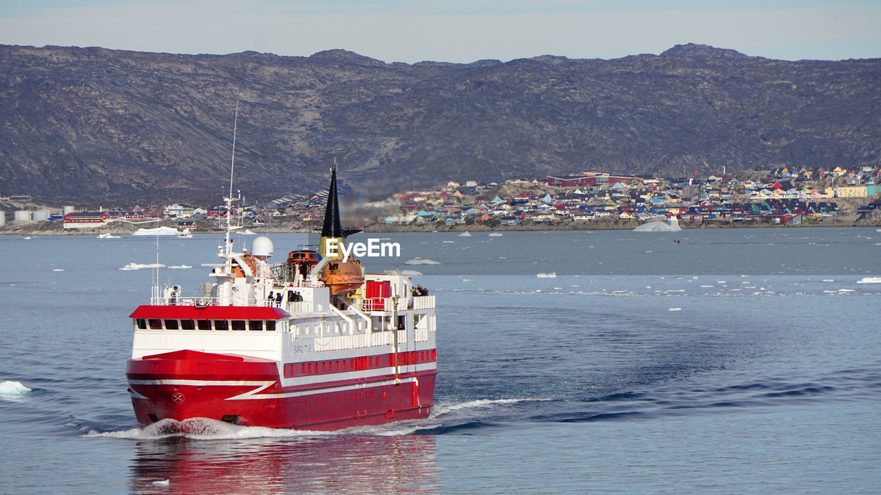 A ship leaves the port of ilulissat on greenland