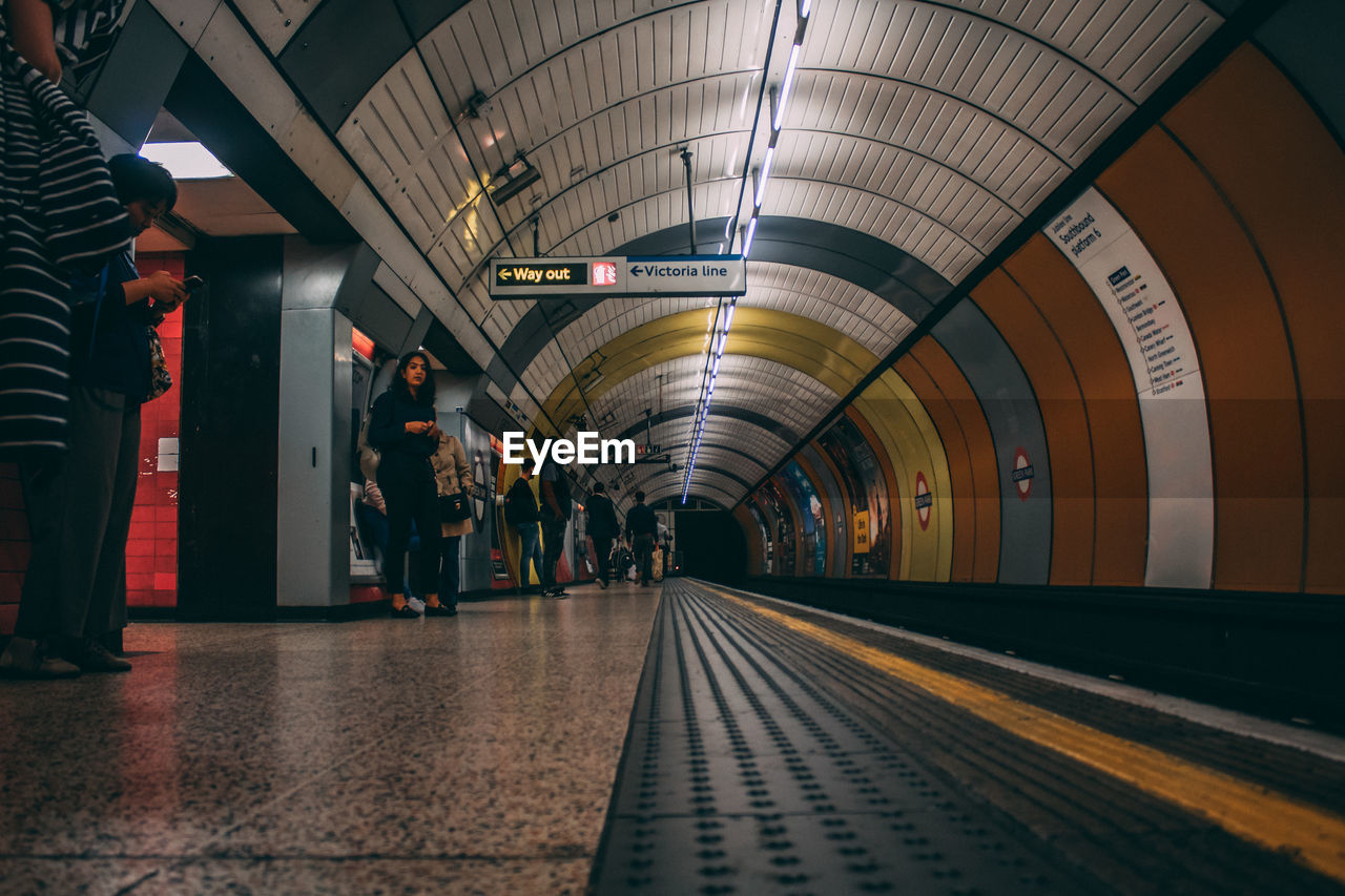 PEOPLE WALKING ON SUBWAY STATION PLATFORM